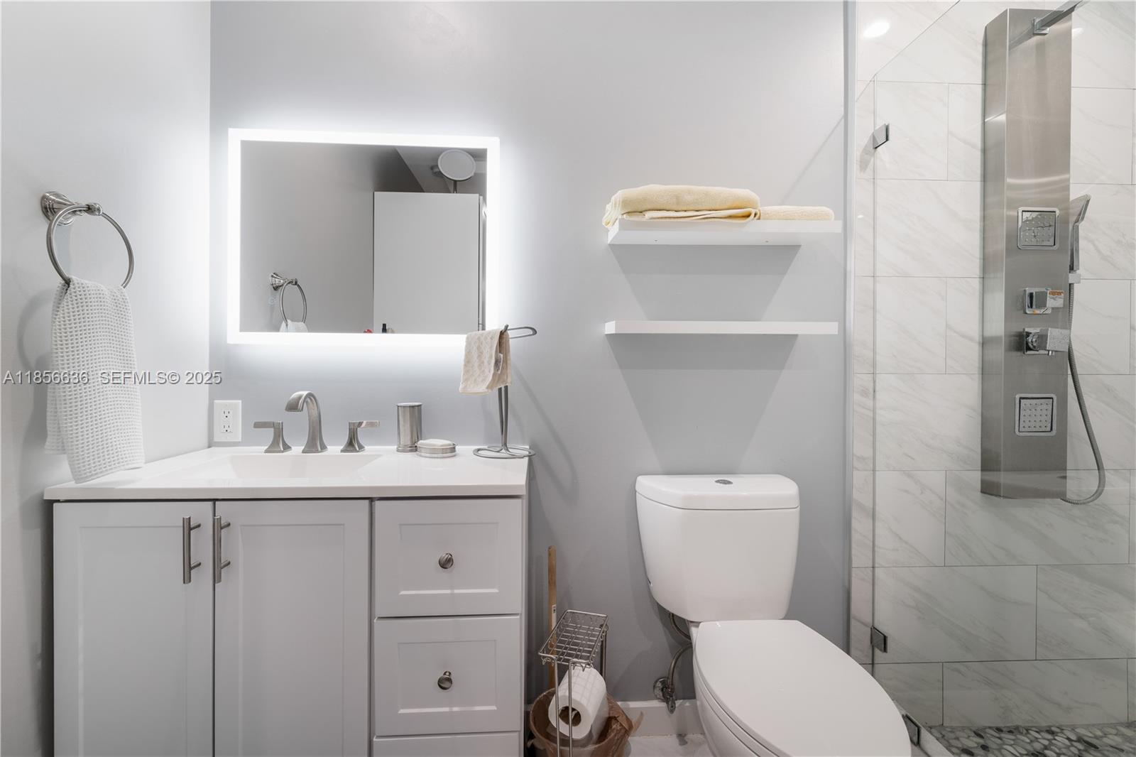 512 Northwest 13th Street Homestead, FL 33030 - Photo 19 of 39 a bathroom with a toilet sink and mirror