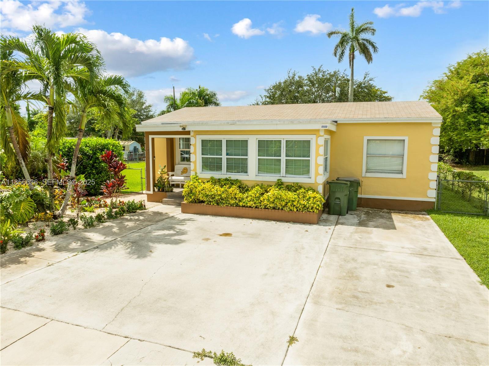 512 Northwest 13th Street Homestead, FL 33030 - Photo 34 of 39 a front view of a house with a yard and potted plants