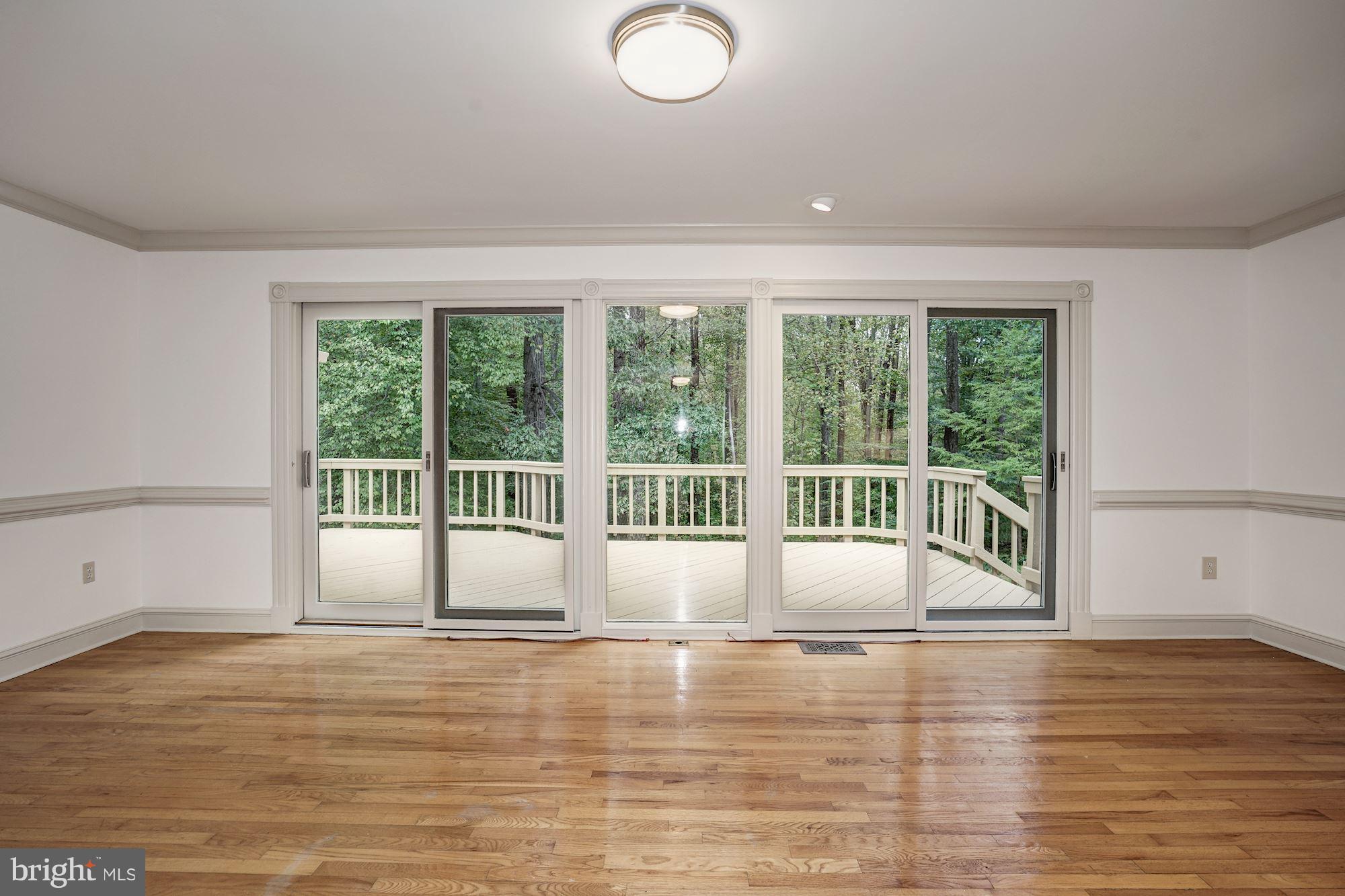 6201 Tyner Street Springfield, VA 22152 - Photo 4 of 30 Living Room: 5-panel Sliders. Great Wooded Views!