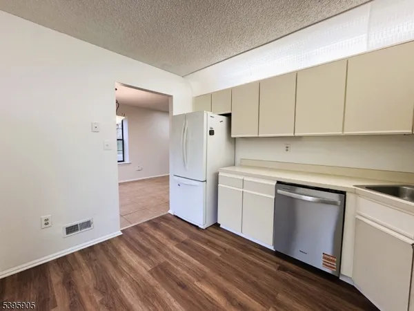 a kitchen with a sink cabinets and stainless steel appliances