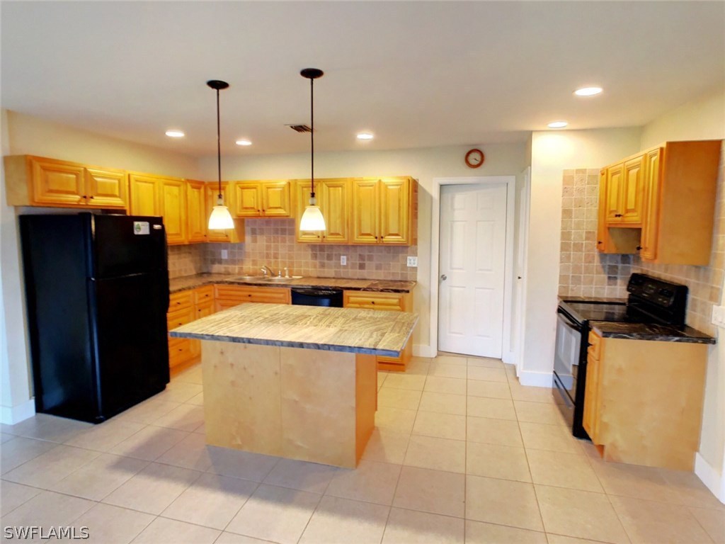 18531 Geranium Road Fort Myers, FL 33967 - Photo 1 of 11 a kitchen with stainless steel appliances granite countertop a refrigerator and a stove