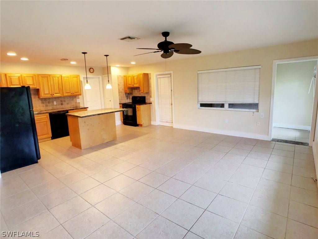 18531 Geranium Road Fort Myers, FL 33967 - Photo 3 of 11 a view of a kitchen with kitchen island stainless steel appliances refrigerator sink and cabinets