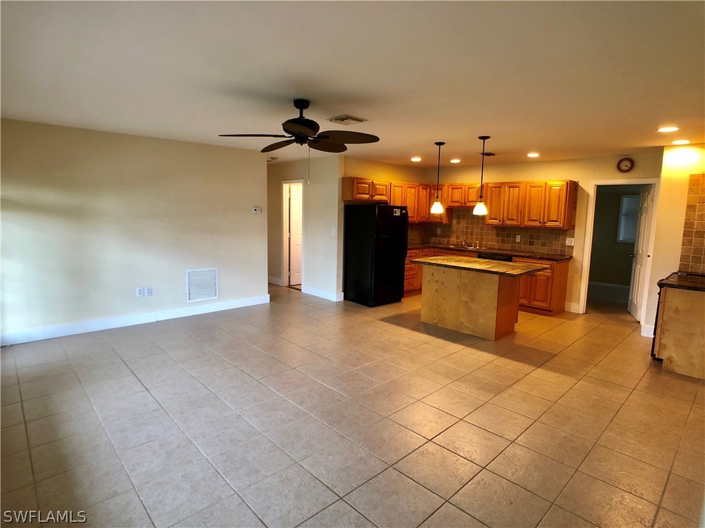18531 Geranium Road Fort Myers, FL 33967 - Photo 4 of 11 a view of a kitchen with a sink and a refrigerator