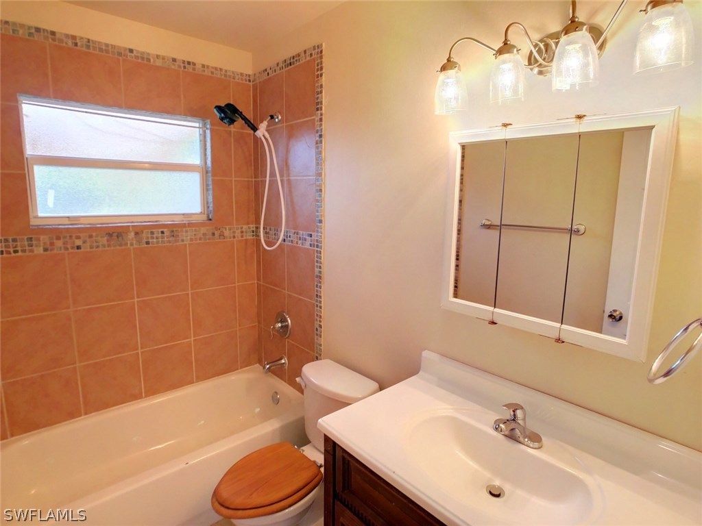 18531 Geranium Road Fort Myers, FL 33967 - Photo 6 of 11 a bathroom with a sink toilet and shower