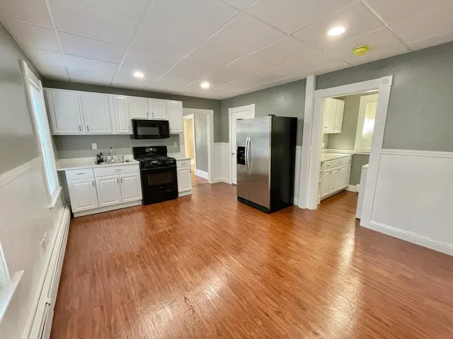 a kitchen with a refrigerator and a stove top oven