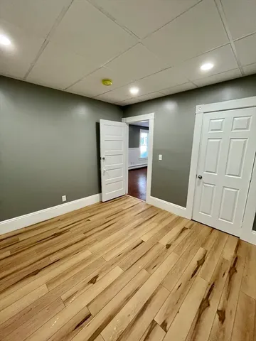 a room with a bed and wooden cabinets