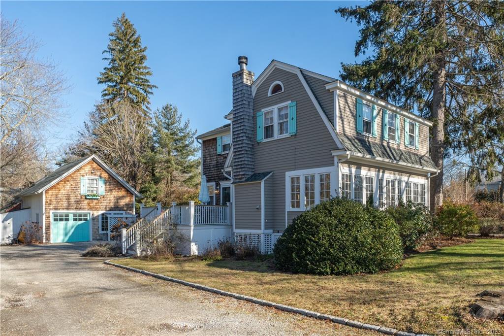 53 Liberty Street Madison, CT 06443 - Photo 1 of 1 a front view of a house with a garden
