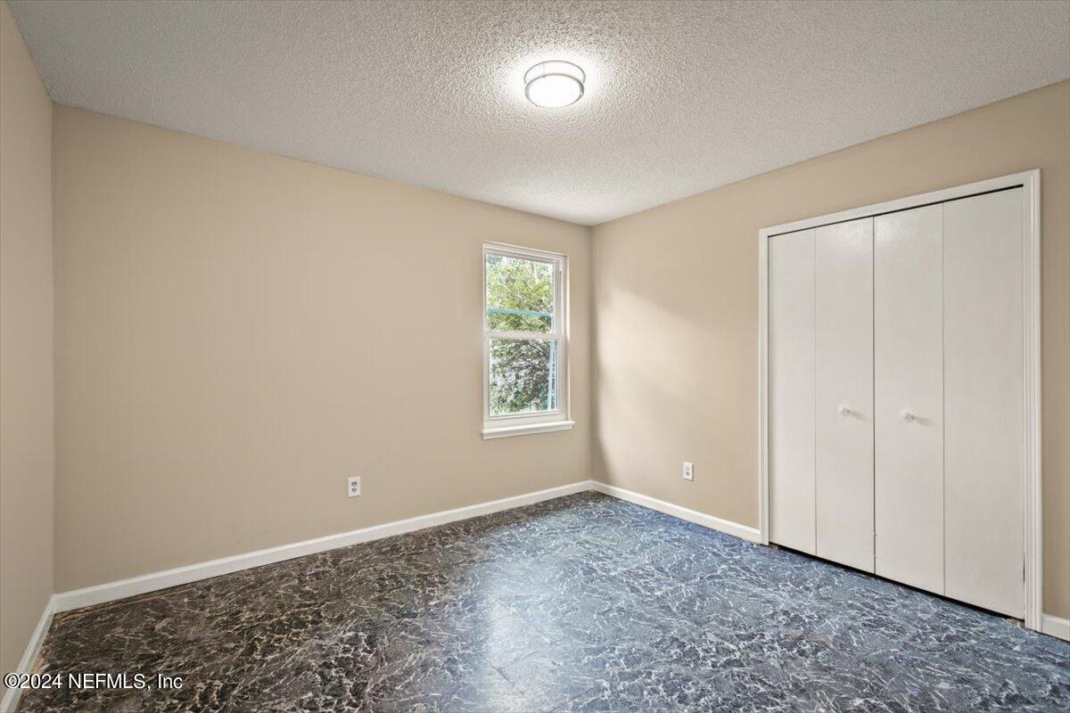 2432 Wattle Tree Road East Jacksonville, FL 32246 - Photo 15 of 25 a view of an empty room with window and closet area