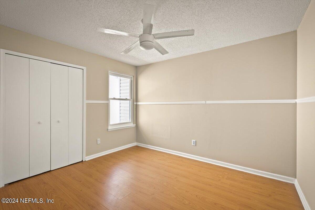 2432 Wattle Tree Road East Jacksonville, FL 32246 - Photo 17 of 25 an empty room with a window and ceiling fan