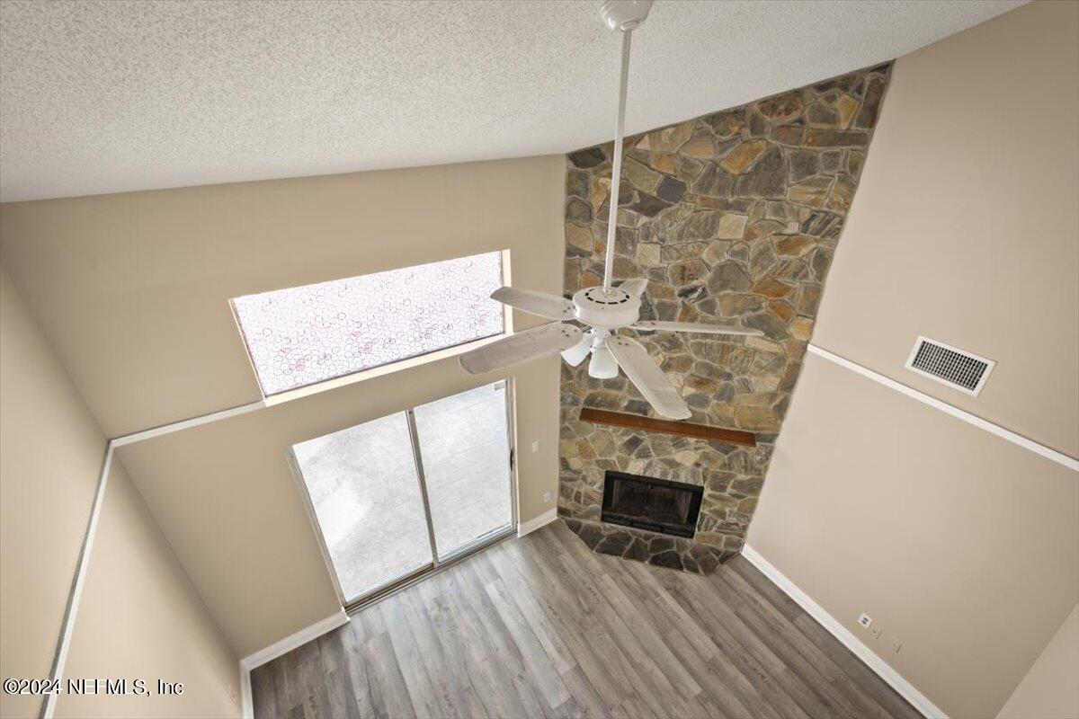 2432 Wattle Tree Road East Jacksonville, FL 32246 - Photo 19 of 25 a view of a livingroom with wooden floor and a fireplace