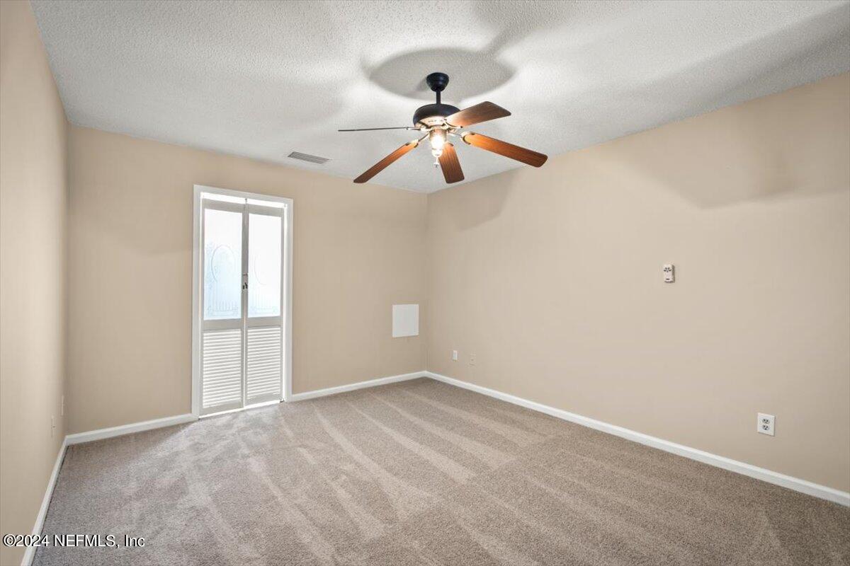 2432 Wattle Tree Road East Jacksonville, FL 32246 - Photo 20 of 25 a view of a room with a ceiling fan and window