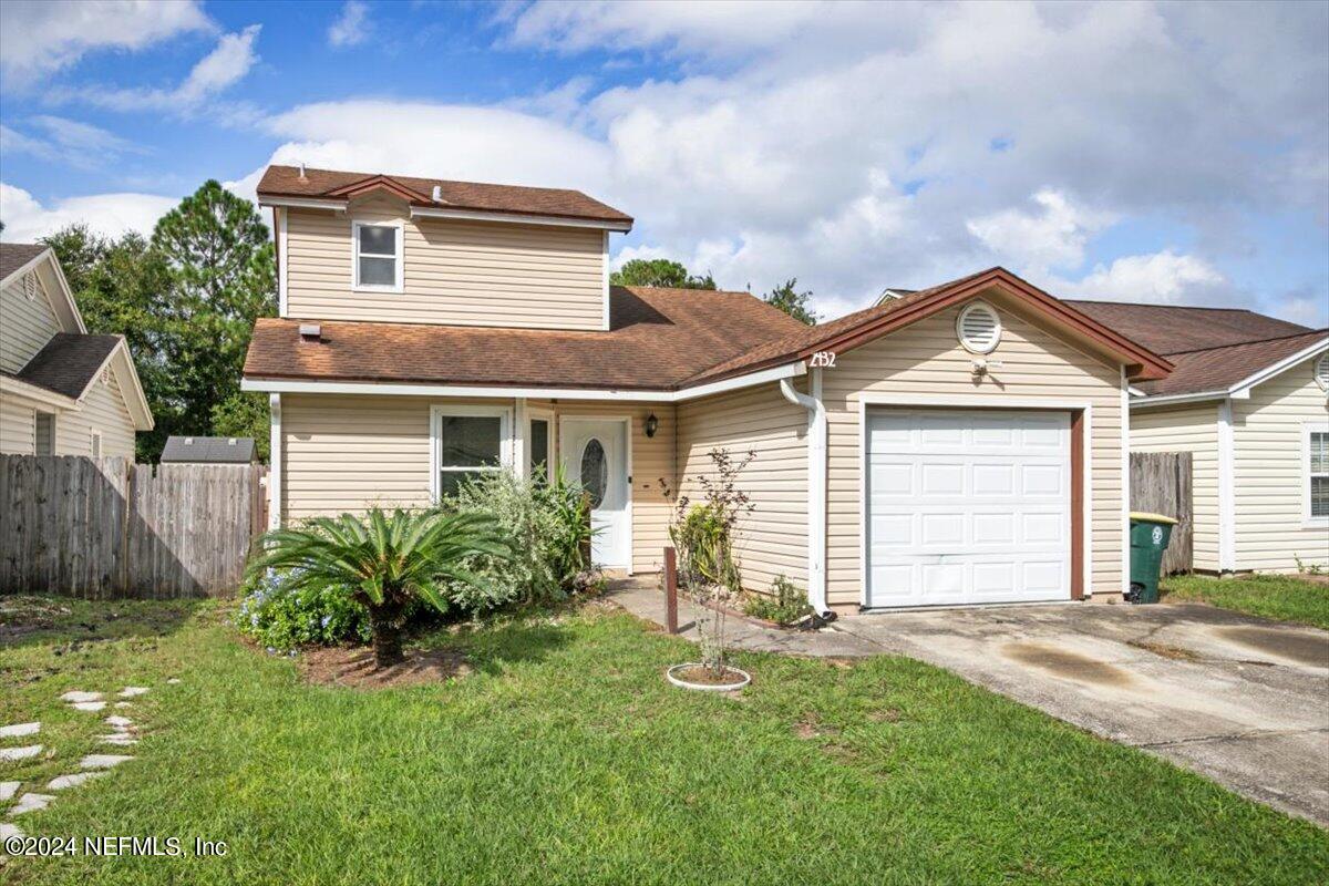 2432 Wattle Tree Road East Jacksonville, FL 32246 - Photo 2 of 25 a front view of a house with a yard