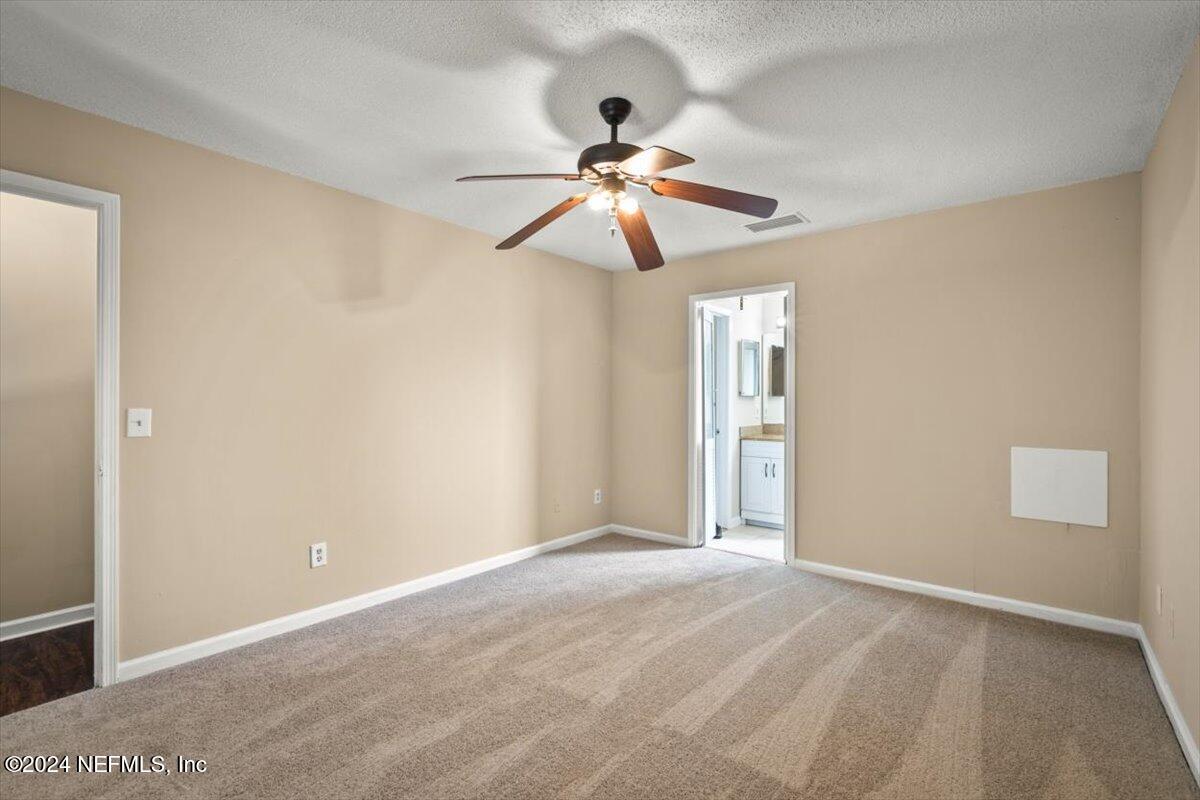 2432 Wattle Tree Road East Jacksonville, FL 32246 - Photo 21 of 25 a view of an empty room and chandelier fan