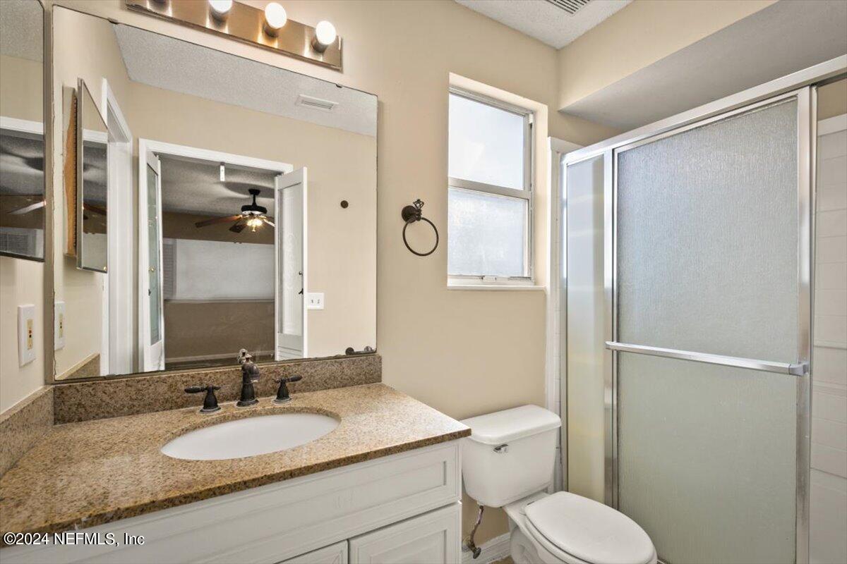 2432 Wattle Tree Road East Jacksonville, FL 32246 - Photo 23 of 25 a bathroom with a granite countertop toilet sink and mirror