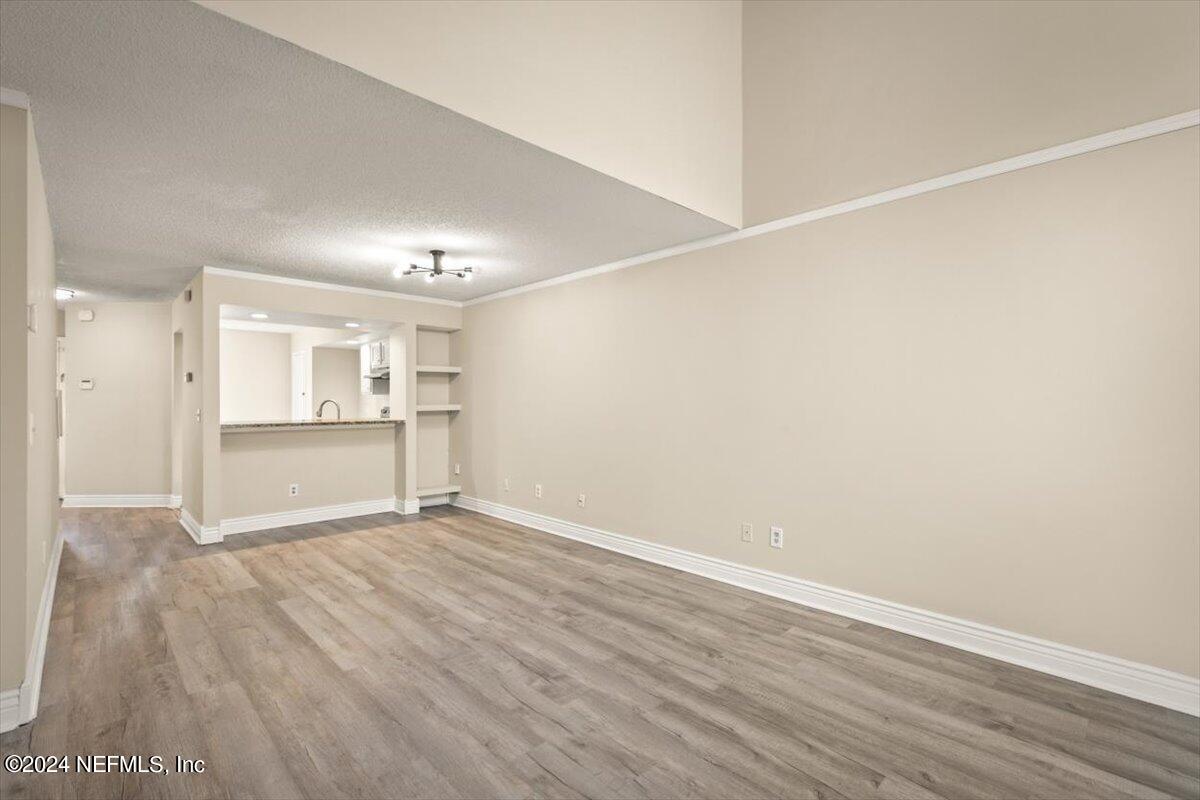 2432 Wattle Tree Road East Jacksonville, FL 32246 - Photo 9 of 25 a view of an empty room with wooden floor