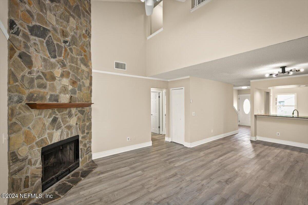 2432 Wattle Tree Road East Jacksonville, FL 32246 - Photo 10 of 25 a view of a livingroom with wooden floor and a fireplace