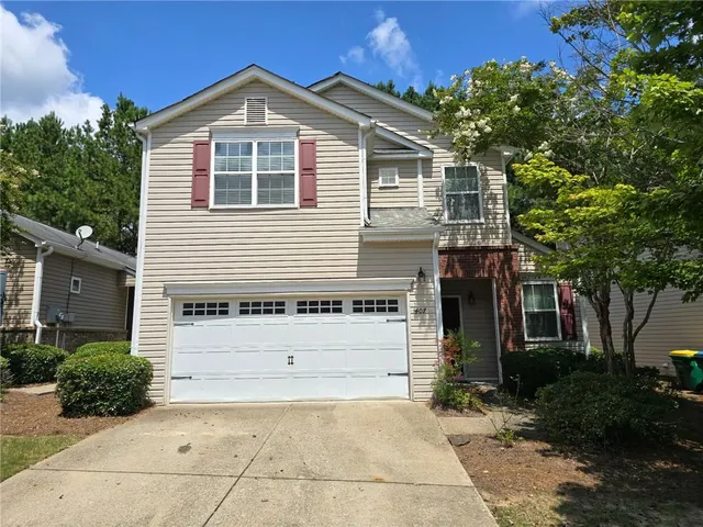 a front view of a house with a yard