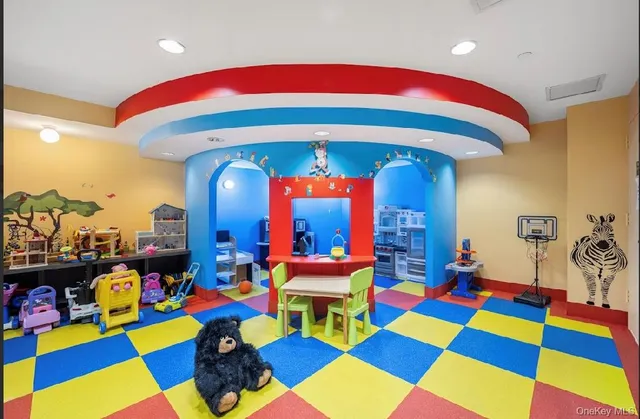 a room with lots of air hockey table and paintings on the walls