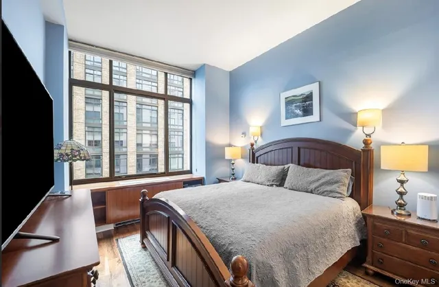 a bedroom with a bed and a large window