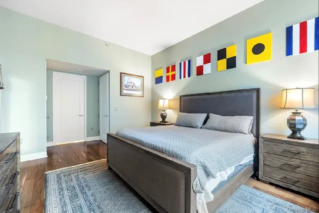 a bedroom with a bed cabinets and window