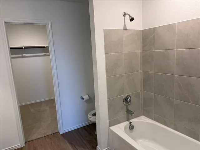 a bathroom with a tub and shower