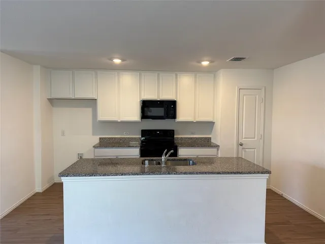 a kitchen with a sink and cabinets