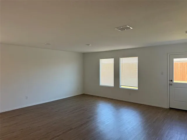 a kitchen with kitchen island granite countertop a sink a stove and cabinets