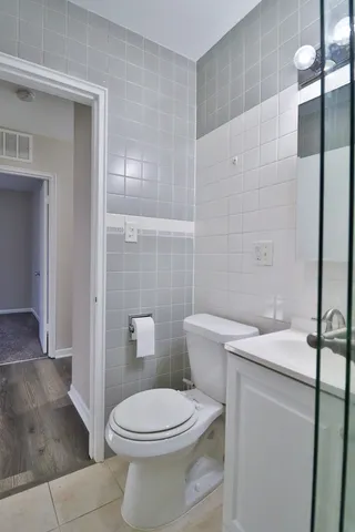 a white toilet sitting next to a bathroom sink