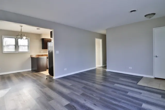a view of a kitchen with wooden floor and a kitchen