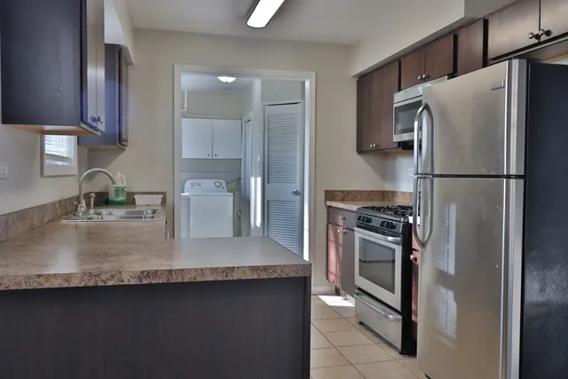 a kitchen with a refrigerator sink and stove