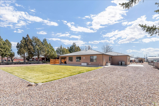 357 East Main Street Enterprise, UT 84725 - Photo 58 of 71 Rear view of property featuring a fenced backyard, a metal roof, and stucco siding