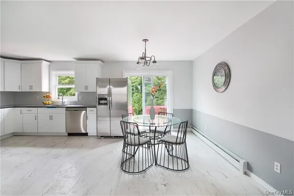 a kitchen with granite countertop stainless steel appliances and white cabinets