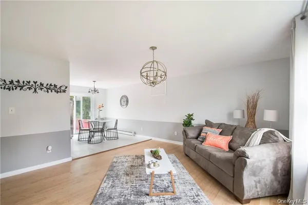 a kitchen with stainless steel appliances kitchen island granite countertop a stove a refrigerator a kitchen island a table and chairs in it