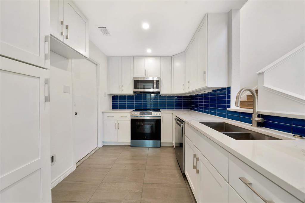 2909 Normandy Court Euless, TX 76039 - Photo 12 of 36 a kitchen with white cabinets and white appliances