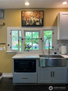 a kitchen with a sink and large window