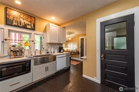 a kitchen with stainless steel appliances kitchen island granite countertop a refrigerator and a stove top oven