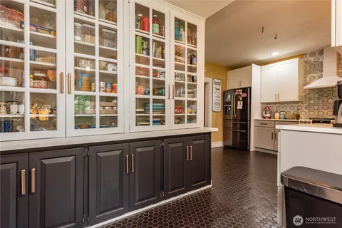 a kitchen with a stove a refrigerator and a sink