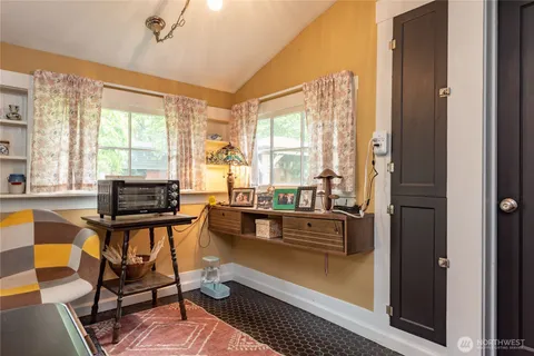 a living room with furniture and floor to ceiling windows