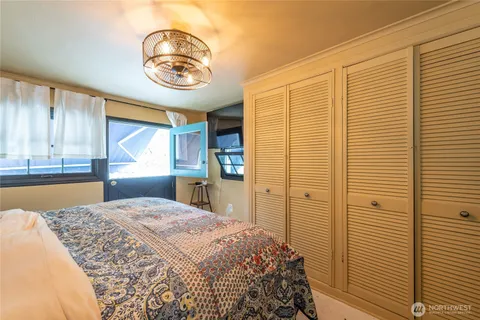 a bedroom with a bed and a window