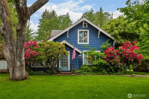 a view of a house with a yard and garden