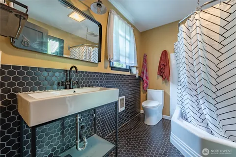 a bathroom with a sink toilet and mirror