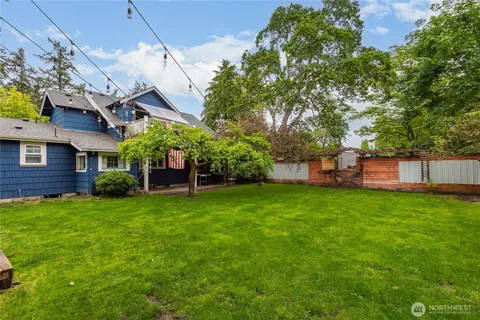 a view of a house with a backyard