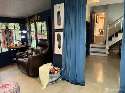 a living room with fireplace furniture and a window