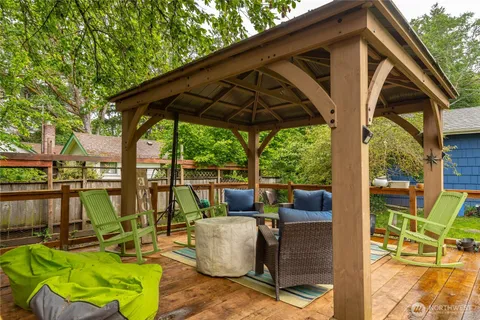 a view of deck with table and chairs under an umbrella