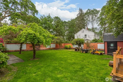 a view of a house with a yard and sitting area