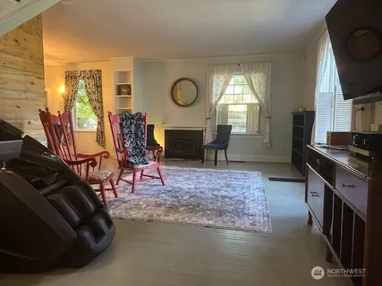 a living room with furniture a window and a fireplace