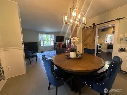a view of a dining room with furniture and a chandelier