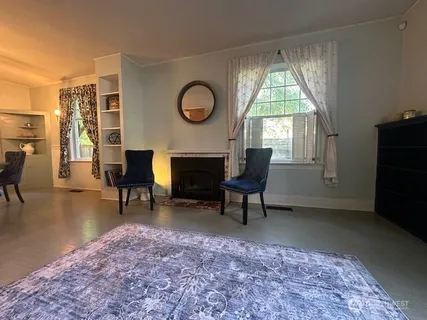 a living room with furniture a window and a fireplace