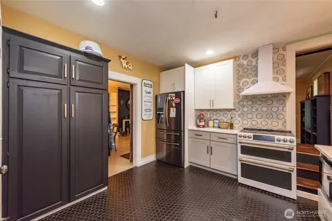 a kitchen with stainless steel appliances a refrigerator and a stove top oven