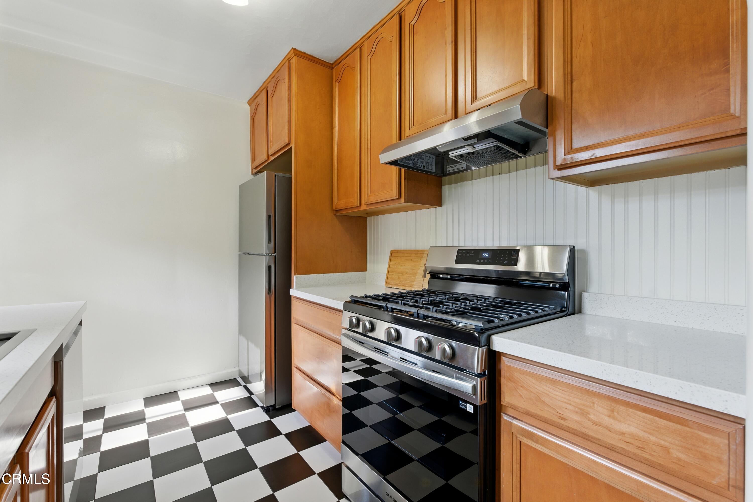 1545 Riverside Drive Glendale, CA 91201 - Photo 5 of 19 a kitchen with stainless steel appliances granite countertop a stove and a refrigerator